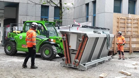 Industrial HVAC cooling system offloading process on construction site using Stock Footage 336461892