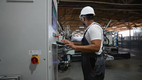 Industrial Indian worker programmer checking the conveyor Stock Footage 283007064