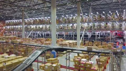 Industrial interior big modern logistic terminal,conveyor with boxes,aerial shot Stock Footage 122123443