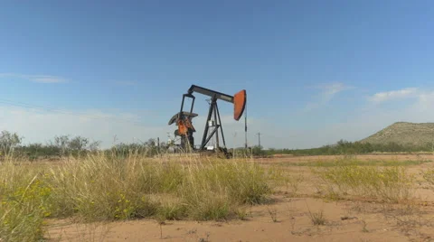 Industrial jack pump platform working on oil field in Texas Stock Footage