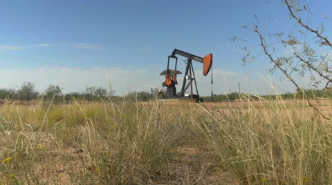 Industrial jack pump platform working on oil field in Texas Stock Footage 62221111