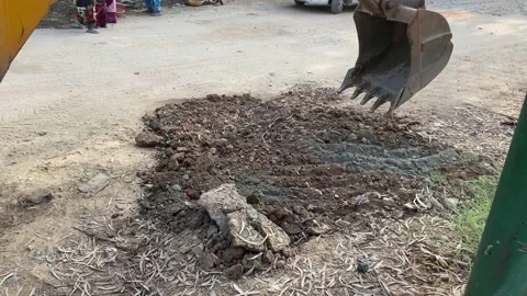 An industrial JCB machine working on digging up the land Stock Footage 167694480