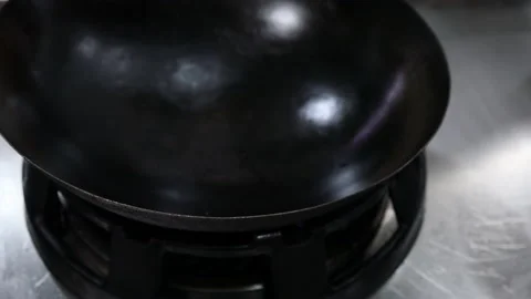 Industrial kitchen fire of a restaurant igniting and placing wok on top Stock Footage 220721977