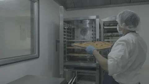 Industrial kitchen staff loading trays into a rack Stock-Footage 327354944
