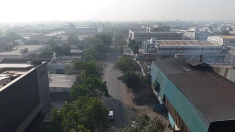 Industrial landscape featuring a mix of completed factory buildings and an Stock Footage 333539188