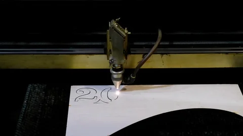 Industrial laser is cutting a pattern, numbers 2020, on a plywood sheet . Stock Footage 120710448
