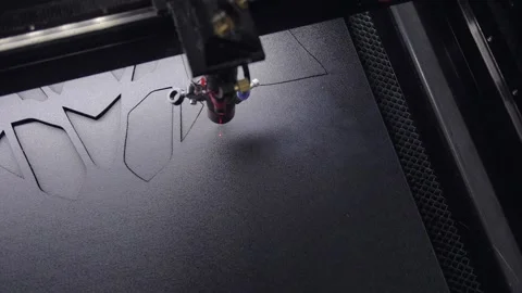 Industrial laser is cutting a pattern on a plastic Stockbeeldmateriaal 153416108