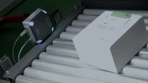 An industrial laser sensor on a conveyor detects the passage of a white box  스톡 동영상 167370886