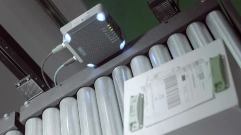 An industrial laser sensor on a conveyor detects the passage of a white box  스톡 동영상 167371164
