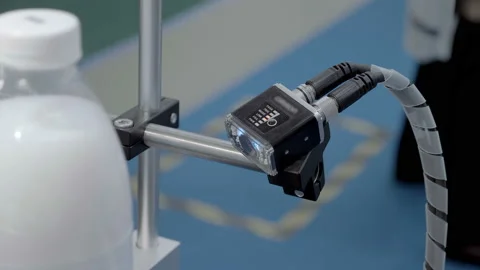 An industrial laser sensor on a conveyor detects the passage of a milk bottles 스톡 동영상 167390900