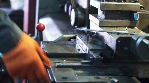 Industrial lathe operator adjusting machine controls during metalwork manuf.. Stock Footage 337475289