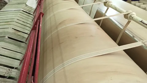 In an industrial laundry, a large drum press for ironing clothes is spinning Stock Footage 160829995