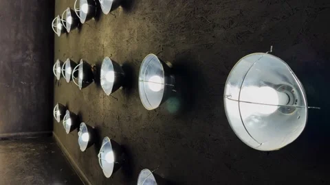 Industrial Lightbulbs Illuminating Dark Studio Wall in Modern Interior Setting Stock Footage 337460986