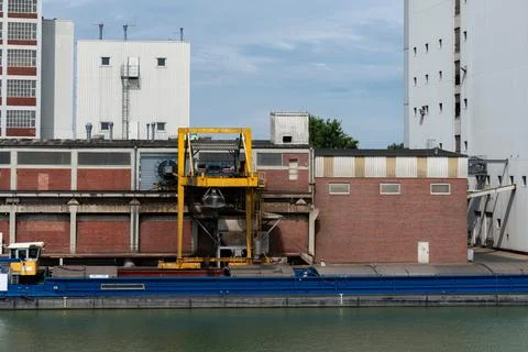 Industrial loading dock adjacent to calm waterway in urban setting Stock Photos