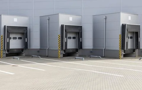 Industrial loading dock with shutter doors and safety markings. Stock Photos