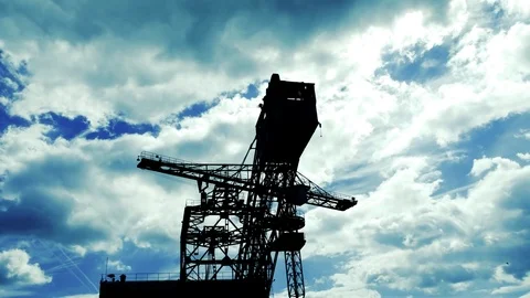 Industrial machine backlight passing clouds Video stock 78435020