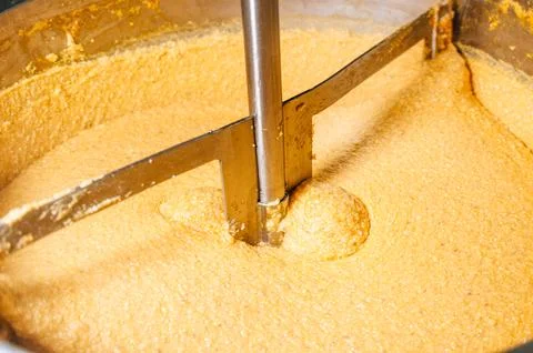 Industrial machine mixing corn dough for tamales preparation Stock Photos