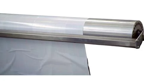 Industrial machine roller processing a thin transparent plastic film. Autom.. Stock Photos