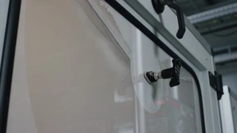 Industrial machine window with suction cup handle in modern factory facility Stockbeeldmateriaal 156057576