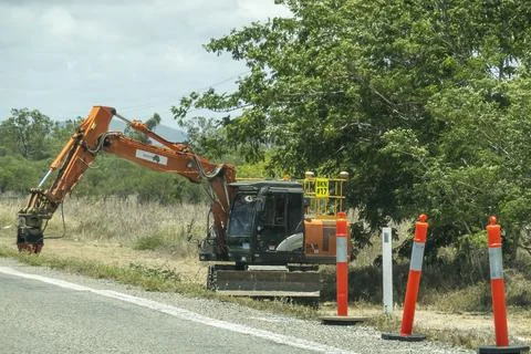 Industrial Machine At work On Side Of Highway Stock Photos