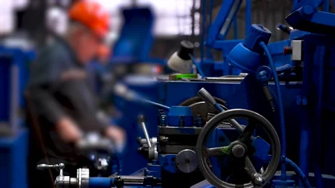 Industrial machine with worker in background. Video stock 343234116