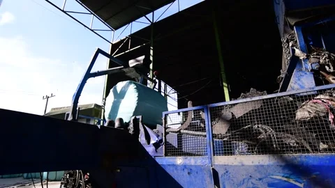 Industrial Machine Wrapping Compressed Waste in Plastic Film Stock-Footage 347400543