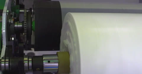 Industrial machinery processing white plastic roll in factory Video stock 303633855