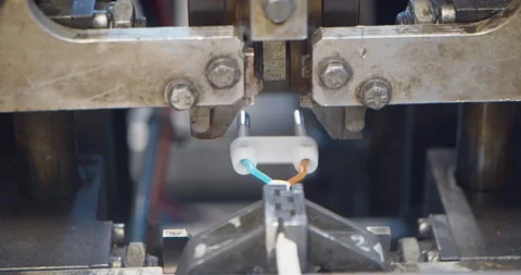 Industrial machinery separates two wires and connects them to the plug Stock Footage 154798677
