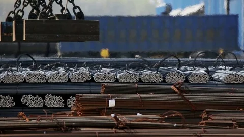 Industrial magnet loading steel bars by the railway m/s Stock Footage 72424197