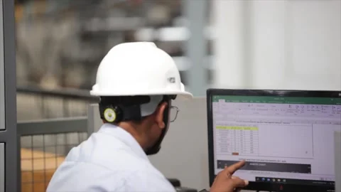 Industrial manager hand pointing toward a specific data point on a monitor Stock Footage 327853715