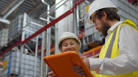 Industrial manager with tablet talking to supervisor and doing warehouse Stock Footage 143555867