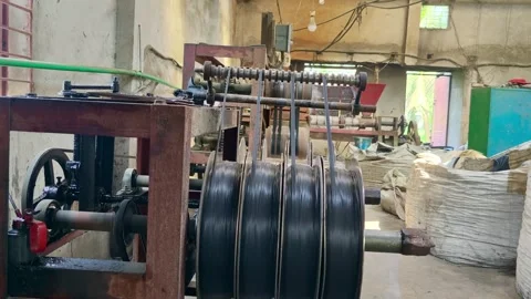 Industrial manufacturing machine operating with plastic wire rolling in a fa 스톡 동영상 346970968