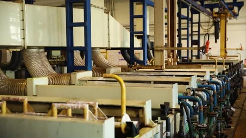 The Industrial Manufacturing Process within a Factory Setting involves numerous Stock Footage 285981077