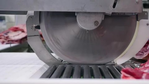 Industrial meat cutting machine slicing pork in slaughterhouse, food processing Stock Footage 334937306