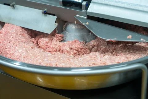 Industrial Meat Processing Machine with Fresh Ground Meat Stock Photos
