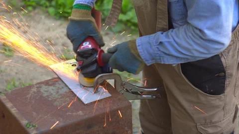 Industrial Metal Grinding with Angle Grinder and Sparks 動画素材 336234805
