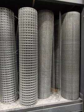 Industrial metal mesh with galvanized surface stored in rolled bundles insi.. Stock Photos
