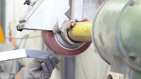 Industrial metal processing. Worker polishing stainless steel Stock Footage 93123224