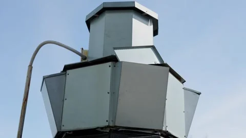 Industrial metal ventilation structure with grey panels against blue sky Stock Footage 332432070