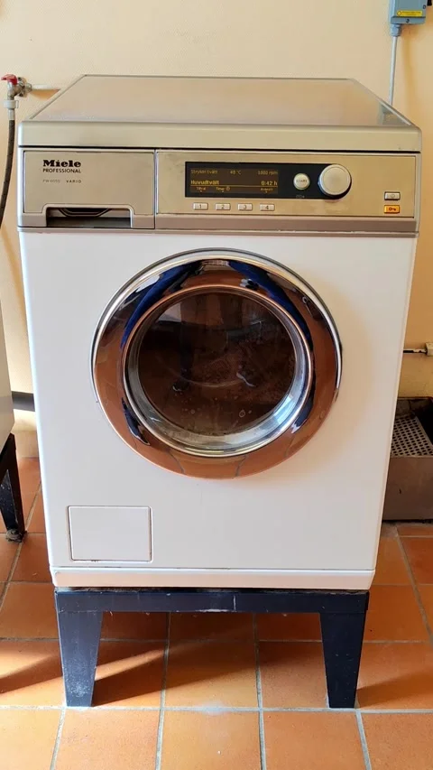 Industrial Miele washer in functional laundry setup 스톡 동영상 313383004