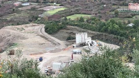 Industrial Mining Crusher and Heavy Trucks Operating in Montenegro Quarry Stock Footage 322520138