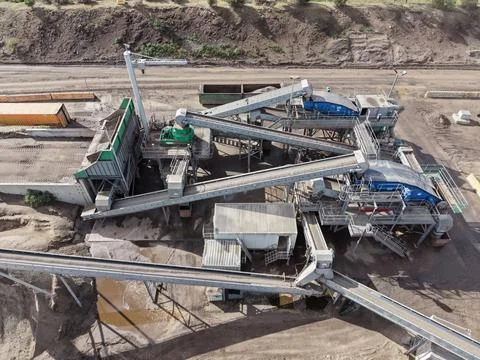 Industrial mining equipment processing raw materials at quarry Stock Photos