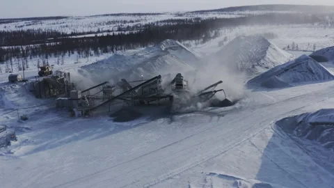 Industrial mining facility in snowy landscape with conveyor belts, machinery, an Stock Footage 310186723