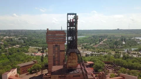 Industrial mining mine red iron ore headframe aerial drone takeoff up camera Stock Footage 196394575
