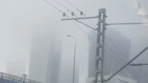 Industrial misty view from train window. Fog all over the city with skyscapes. Stock Footage 153527737
