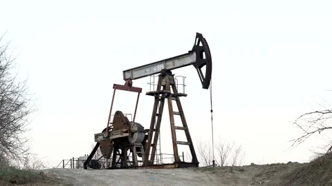 Industrial oil pump jack pumping crude oil for fossil fuel energy with drilling  Stock Footage 127795997