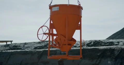 Industrial orange hopper for material distribution at construction site Stockbeeldmateriaal 329558563
