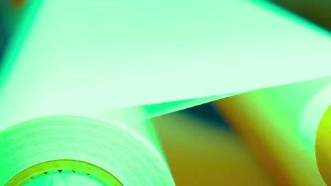 Industrial paper roll processing under bright green uv light setting Stock-Footage 342906054