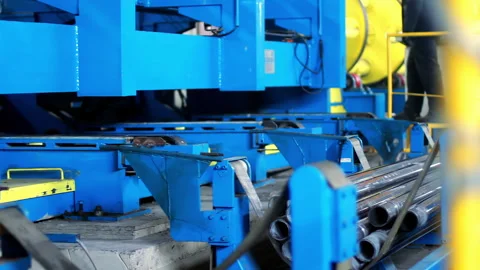 Industrial pipe cutting machine sorting steel tube conveyor. Metalwork plant. Stock Footage 345612560