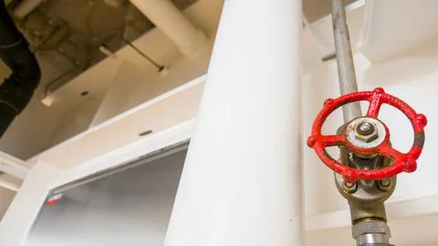 Industrial Pipe System with Red Cast Iron Gate Valve Wheel Stock Photos
